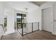 Bright upper landing with hardwood floors, modern railing, and a large window at 1254 Cordova Ne Blvd, St Petersburg, FL 33704