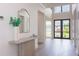 Bright and airy entryway with light wood flooring and a console table at 1254 Cordova Ne Blvd, St Petersburg, FL 33704