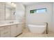 Elegant bathroom featuring a freestanding tub and a herringbone tile floor at 1254 Cordova Ne Blvd, St Petersburg, FL 33704
