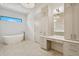 Bathroom with soaking tub, modern vanity, and herringbone tile floor at 1254 Cordova Ne Blvd, St Petersburg, FL 33704