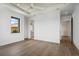 Spacious bedroom with hardwood floors, an ensuite bathroom, and access to hallway at 1254 Cordova Ne Blvd, St Petersburg, FL 33704