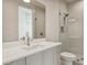 Modern bathroom with a frameless shower, white vanity, and white countertop at 1254 Cordova Ne Blvd, St Petersburg, FL 33704