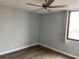 Spacious bedroom with new flooring, fresh paint, and ceiling fan at 255 Dolphin Pt # 809, Clearwater, FL 33767