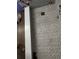 New gray marble-look tiled shower with a modern drain at 255 Dolphin Pt # 809, Clearwater, FL 33767