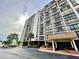 Dolphin Cove building exterior, with parking and landscaping at 255 Dolphin Pt # 809, Clearwater, FL 33767