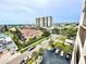 Aerial view of waterfront property, showcasing nearby buildings and boats at 255 Dolphin Pt # 809, Clearwater, FL 33767