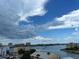 Aerial view of waterfront homes and calm waters under a partly cloudy sky at 255 Dolphin Pt # 809, Clearwater, FL 33767