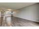 Open living area with wood-look floors and kitchen at 9490 Harbor Greens Way # 205, Seminole, FL 33776