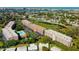 Aerial view of condo community with pool and water access at 9490 Harbor Greens Way # 205, Seminole, FL 33776