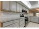 Modern kitchen with granite countertops and stainless steel appliances at 9490 Harbor Greens Way # 205, Seminole, FL 33776