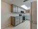 Updated kitchen with granite countertops and gray cabinets at 9490 Harbor Greens Way # 205, Seminole, FL 33776