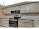 Modern kitchen with stainless steel appliances and gray cabinets at 9490 Harbor Greens Way # 205, Seminole, FL 33776