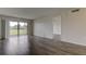 Living room with sliding doors leading to balcony and view at 9490 Harbor Greens Way # 205, Seminole, FL 33776