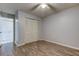 Bedroom with wood-look floors, closet, and access to bathroom at 9490 Harbor Greens Way # 205, Seminole, FL 33776