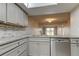 Kitchen boasts granite countertops and stainless steel dishwasher at 9490 Harbor Greens Way # 205, Seminole, FL 33776