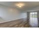 Bright living room with wood-look floors and sliding doors at 9490 Harbor Greens Way # 205, Seminole, FL 33776