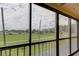 View from a screened balcony overlooking a grassy area at 9490 Harbor Greens Way # 205, Seminole, FL 33776