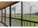 Screened balcony overlooking a lush green landscape at 9490 Harbor Greens Way # 205, Seminole, FL 33776