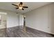 Bright bedroom with laminate flooring, ceiling fan, and access to a bathroom at 9490 Harbor Greens Way # 205, Seminole, FL 33776