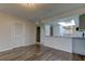 Living room with wood-look floors and access to kitchen at 9490 Harbor Greens Way # 205, Seminole, FL 33776
