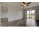 Bedroom with laminate flooring, ceiling fan, and access to balcony at 9490 Harbor Greens Way # 205, Seminole, FL 33776