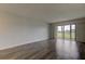 Living room with sliding doors leading to balcony and view at 9490 Harbor Greens Way # 205, Seminole, FL 33776