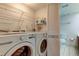 Laundry room with washer, dryer, and shelving at 9490 Harbor Greens Way # 205, Seminole, FL 33776