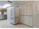 White refrigerator and white louvered pantry doors at 9490 Harbor Greens Way # 205, Seminole, FL 33776