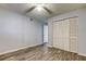 Bedroom with wood-look floors, ceiling fan, and built-in closet at 9490 Harbor Greens Way # 205, Seminole, FL 33776