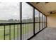 Spacious screened balcony overlooking a green space at 9490 Harbor Greens Way # 205, Seminole, FL 33776