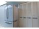 White refrigerator and white louvered pantry doors at 9490 Harbor Greens Way # 205, Seminole, FL 33776