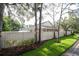 Spacious backyard with a well-maintained fence, lush greenery, and mature trees for privacy at 379 Fan Palm Ne Ct # 0, St Petersburg, FL 33703