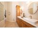 Bathroom featuring a double sink vanity with wood cabinets, white countertops, and tiled floors at 379 Fan Palm Ne Ct # 0, St Petersburg, FL 33703