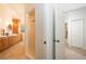 Bright bathroom featuring a double sink vanity with wood cabinets and a walk-in shower with a glass door at 379 Fan Palm Ne Ct # 0, St Petersburg, FL 33703