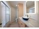 Bathroom featuring a glass shower, stylish sink, and modern fixtures at 379 Fan Palm Ne Ct # 0, St Petersburg, FL 33703