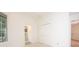 Neutral bedroom with light carpet, a window, and white walls with a door to the en suite bathroom at 379 Fan Palm Ne Ct # 0, St Petersburg, FL 33703