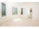 Bright bedroom with carpet, neutral paint and large windows allowing for natural light at 379 Fan Palm Ne Ct # 0, St Petersburg, FL 33703
