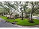 Charming home featuring lush landscaping, mature trees and a welcoming exterior at 379 Fan Palm Ne Ct # 0, St Petersburg, FL 33703