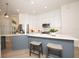 Bright kitchen with an island, stainless appliances, modern pendant lighting, and white cabinetry at 379 Fan Palm Ne Ct # 0, St Petersburg, FL 33703