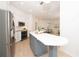 Modern kitchen boasts stainless steel appliances, a large island with seating, and an open concept design at 379 Fan Palm Ne Ct # 0, St Petersburg, FL 33703