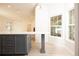 Kitchen island features quartz countertops, gray cabinets, a breakfast bar, and seamlessly connects to the living area at 379 Fan Palm Ne Ct # 0, St Petersburg, FL 33703