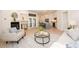 Well-lit living room featuring hardwood floors, comfortable seating, and an open layout to the kitchen at 379 Fan Palm Ne Ct # 0, St Petersburg, FL 33703