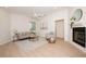 Cozy living room with a fireplace, neutral décor, and hardwood floors offering a comfortable space at 379 Fan Palm Ne Ct # 0, St Petersburg, FL 33703