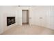 Neutral living room with fireplace, light carpet, and white doors at 379 Fan Palm Ne Ct # 0, St Petersburg, FL 33703