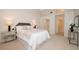 Comfortable main bedroom featuring a vaulted ceiling, cozy carpeting, and access to a walk-in closet at 379 Fan Palm Ne Ct # 0, St Petersburg, FL 33703