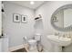 Powder room with pedestal sink and decorative mirror at 5823 Bowen Daniel Dr # 905, Tampa, FL 33616