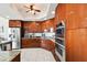 Modern kitchen with wood cabinets and granite counters at 5823 Bowen Daniel Dr # 905, Tampa, FL 33616