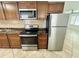 Stainless steel appliances and wood cabinets in this galley kitchen at 2811 Valencia S Way, St Petersburg, FL 33705