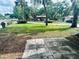 Spacious grassy yard with a flagstone patio and mature trees at 2811 Valencia S Way, St Petersburg, FL 33705
