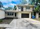 House exterior featuring a two-story home with a balcony and attached garage at 2811 Valencia S Way, St Petersburg, FL 33705